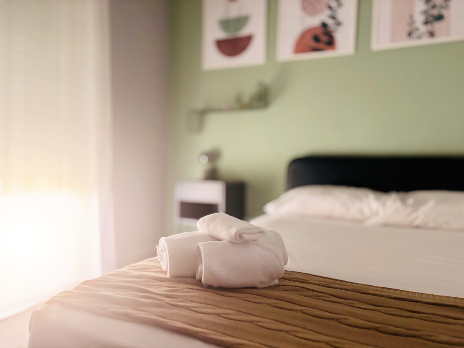 Comfortable bedroom with welcome towels